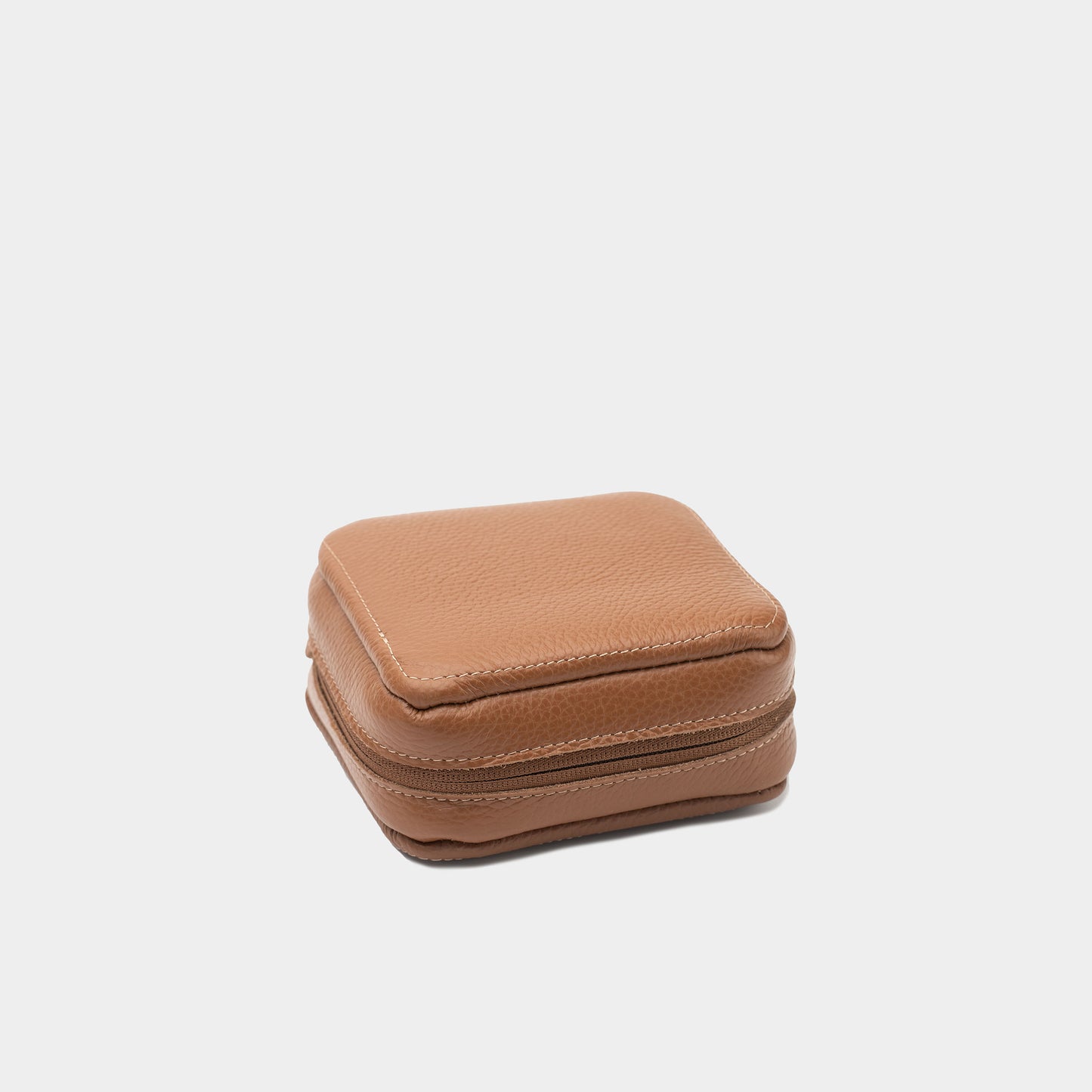 Closed brown leather case for Mac Mini with visible stitching and zip-around closure