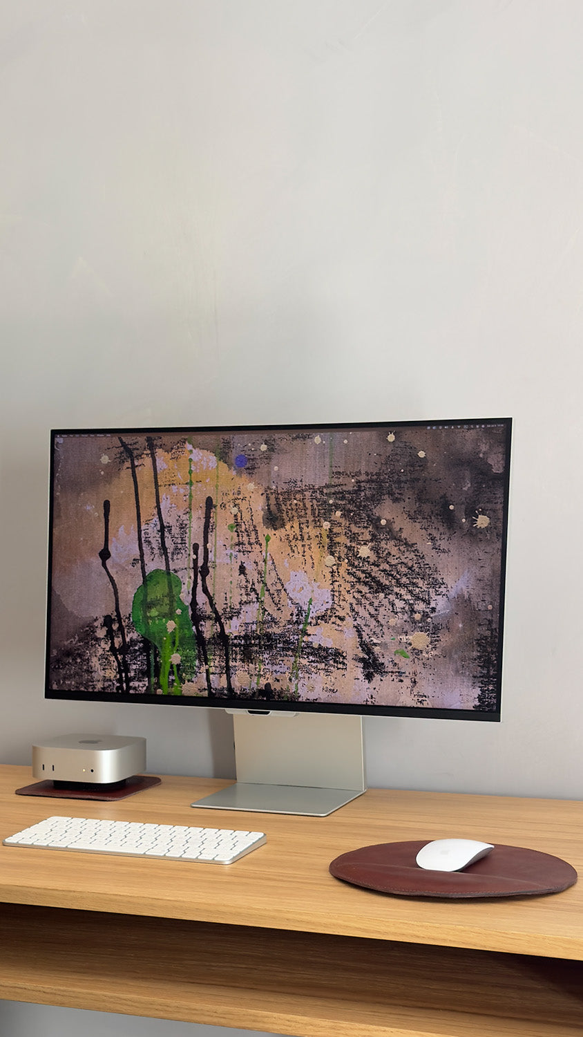 Round leather mouse pad with Apple Magic Mouse on wooden desk