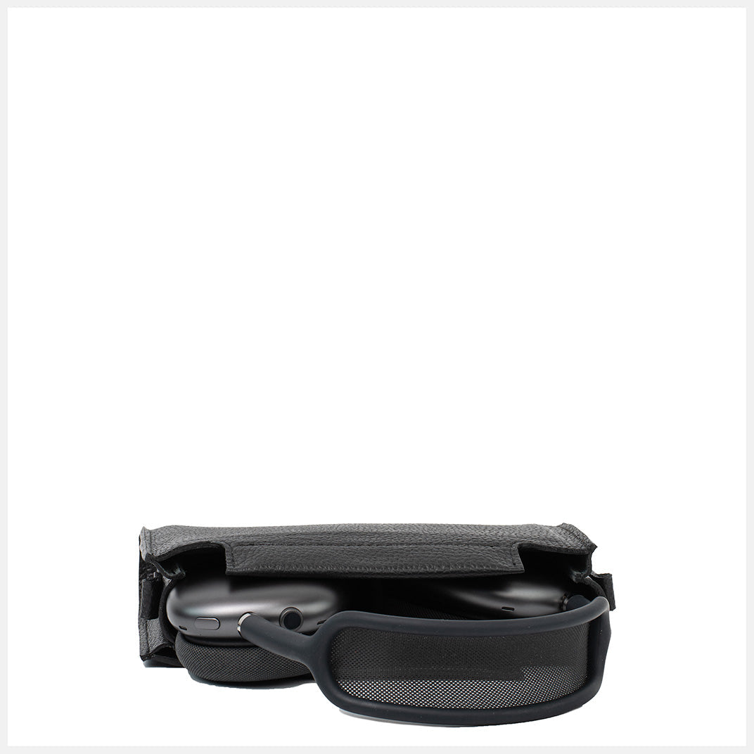 AirPods Max partially stored inside open black leather case with headband resting outside.
