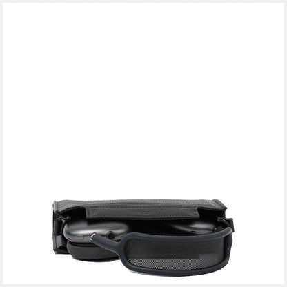 AirPods Max partially stored inside open black leather case with headband resting outside.