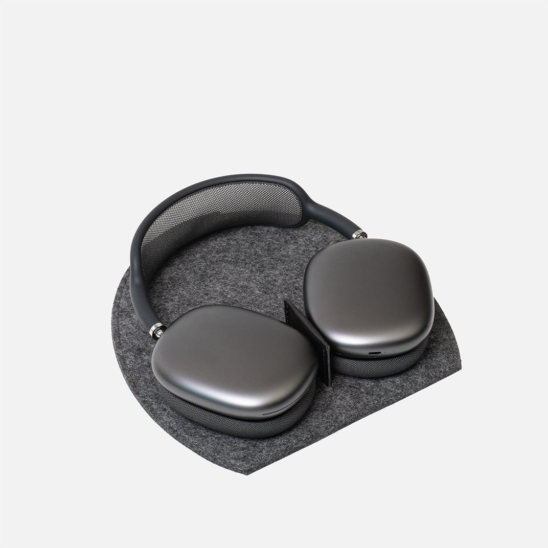 AirPods Max headphones on Rest Station 2.0 in grey wool felt – stand with low power mode activation