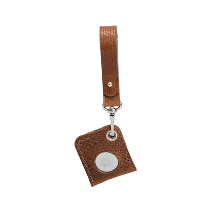Brown snake-print leather AirTag bag charm with a loop strap, front view showing the white AirTag face.