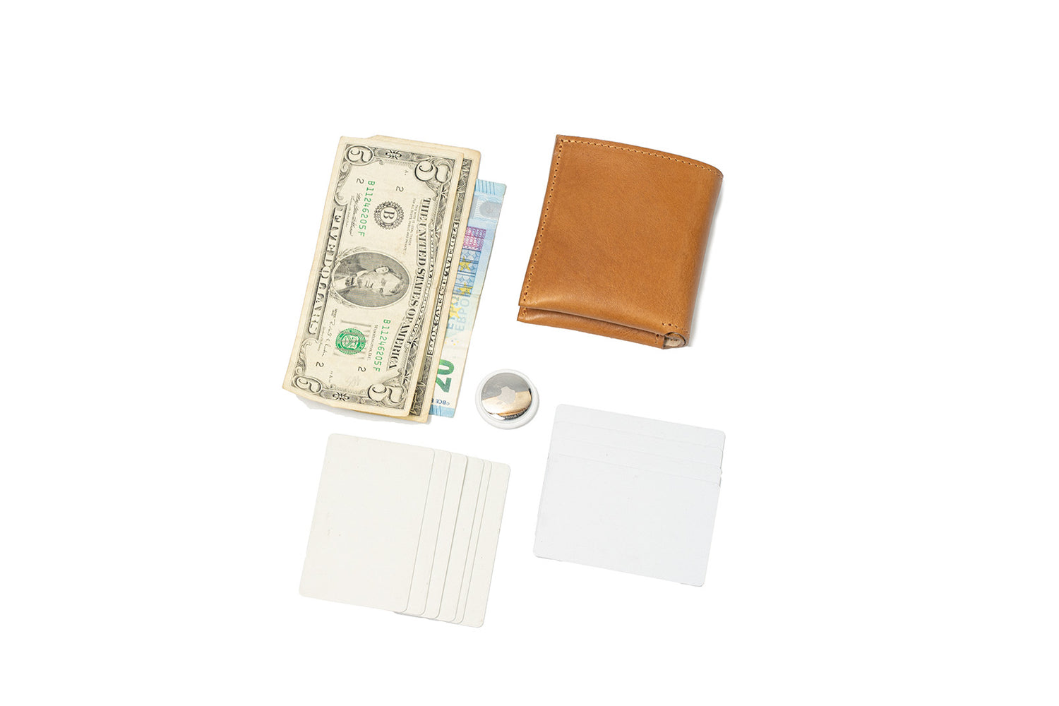 AirTag billfold leather wallet with cash, cards, AirTag, and protective card inserts laid out