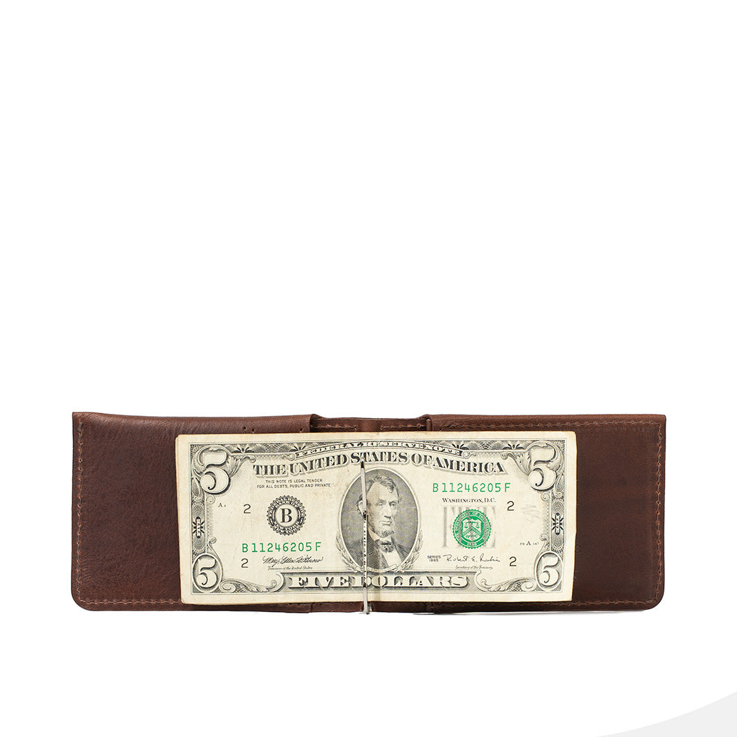 Leather AirTag money clip wallet holding U.S. dollar bills, slim cash-carry design