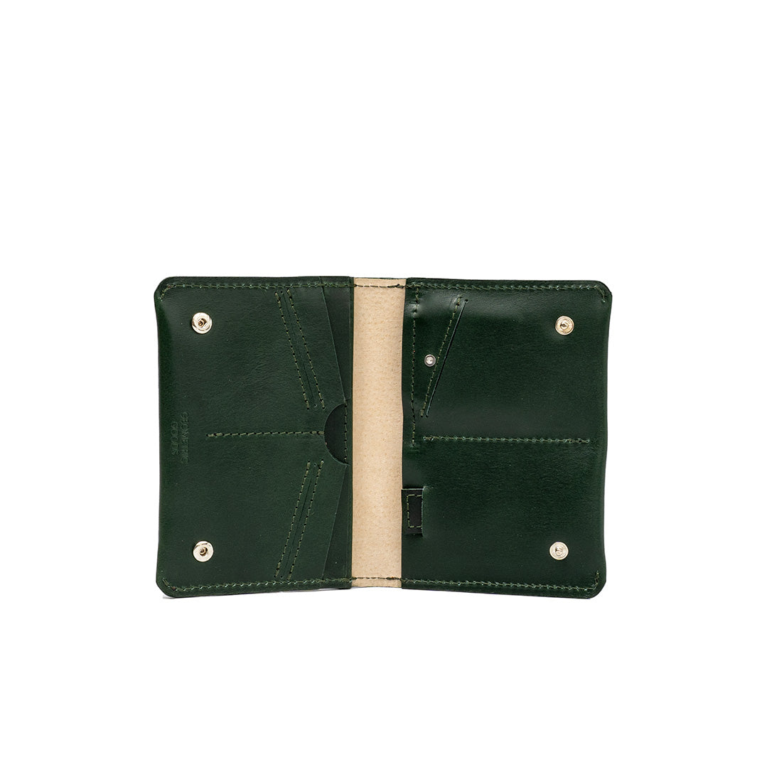 Green leather travel wallet designed to fit an AirTag, featuring multiple compartments for a passport, cards, and cash. The sleek design ensures easy tracking during travel.