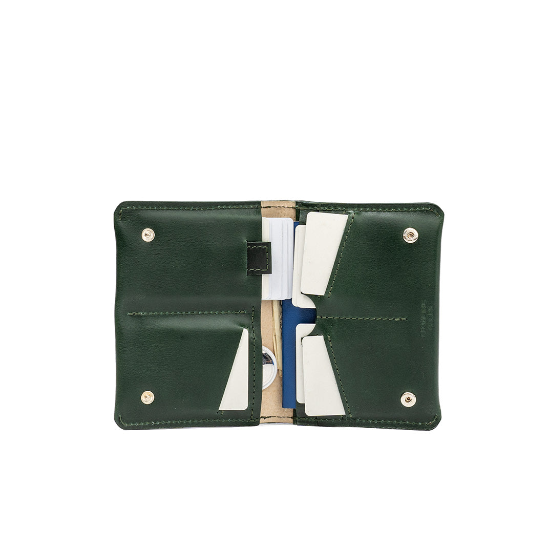 Green leather AirTag passport travel wallet with multiple card slots, a dedicated AirTag pocket, and a secure cash compartment. Ideal for organized travel.