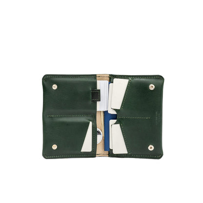 Green leather AirTag passport travel wallet with multiple card slots, a dedicated AirTag pocket, and a secure cash compartment. Ideal for organized travel.
