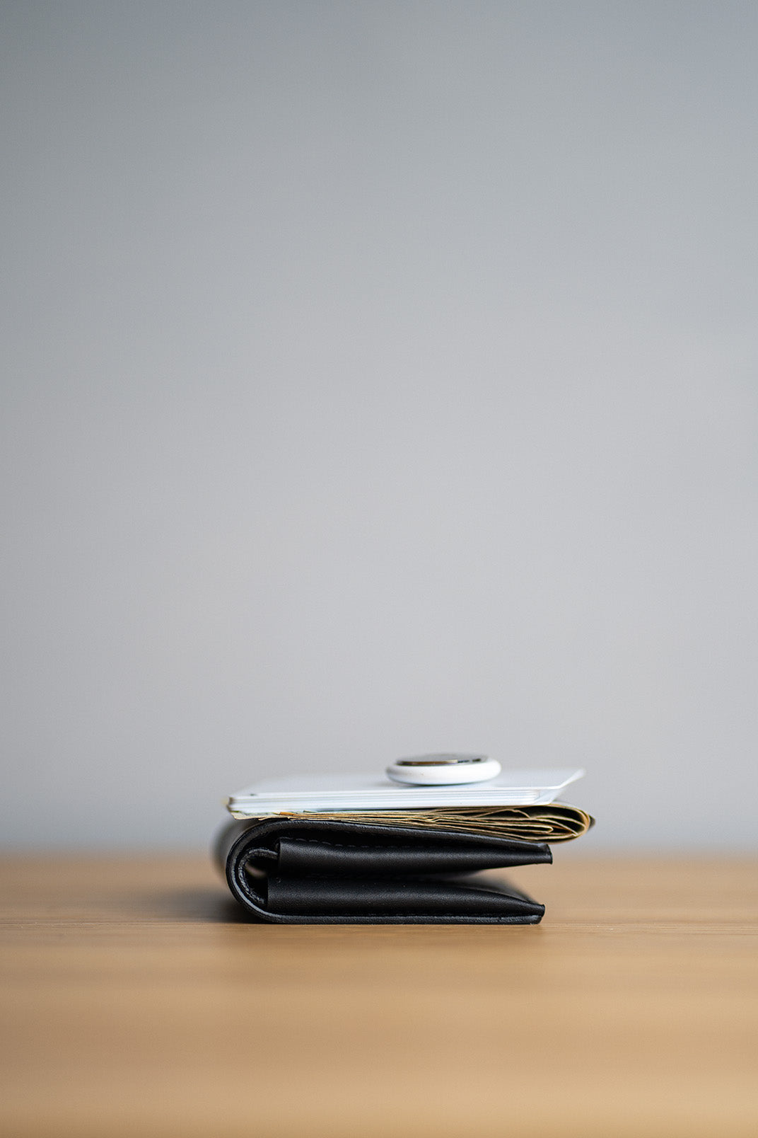 A slim leather billfold wallet featuring an AirTag.