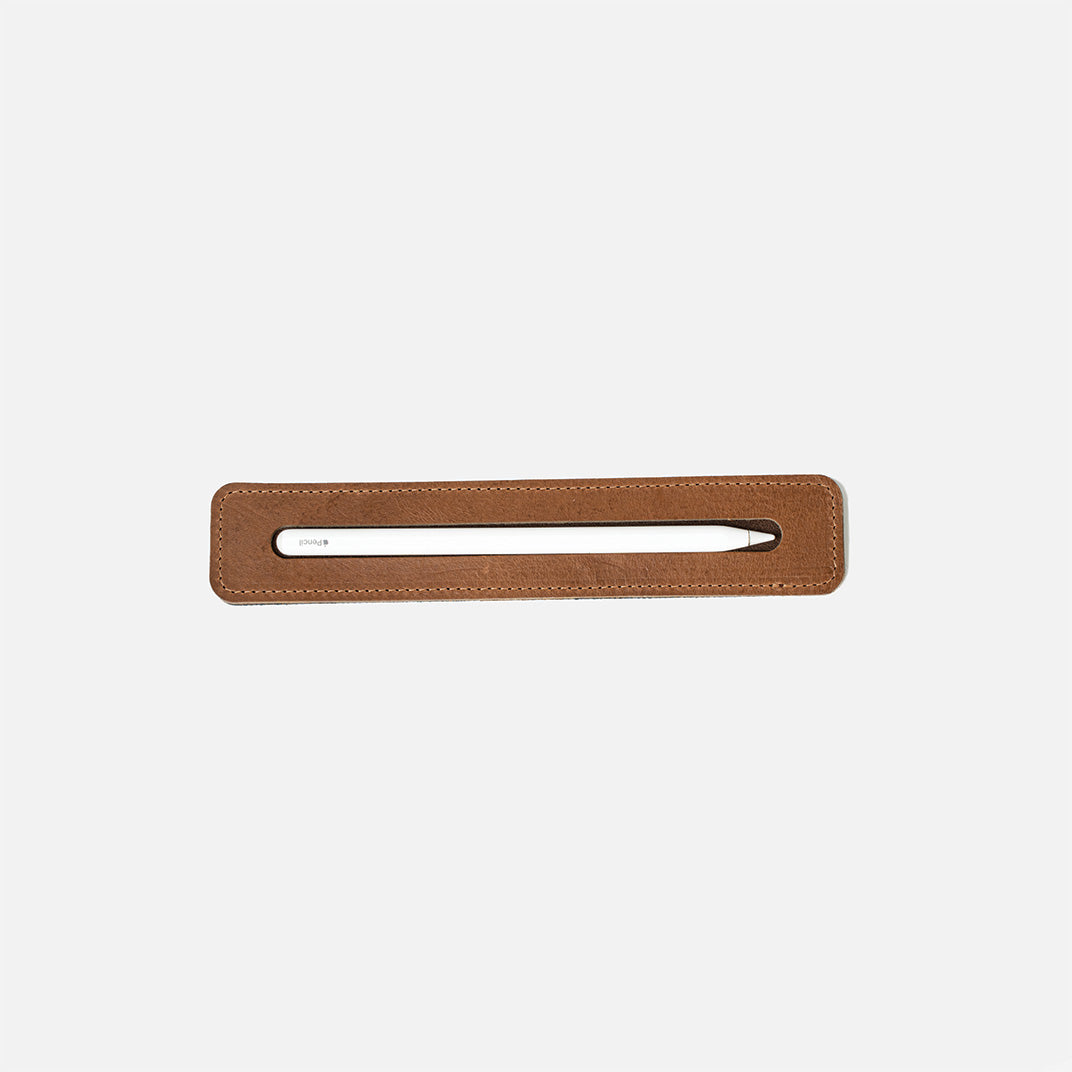 Apple Pencil leather tray in brown, top-down view with stylus in slot
