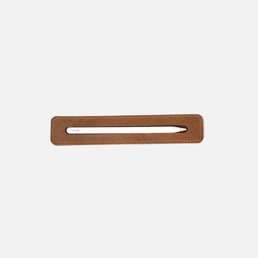 Apple Pencil leather tray in brown, top-down view with stylus in slot