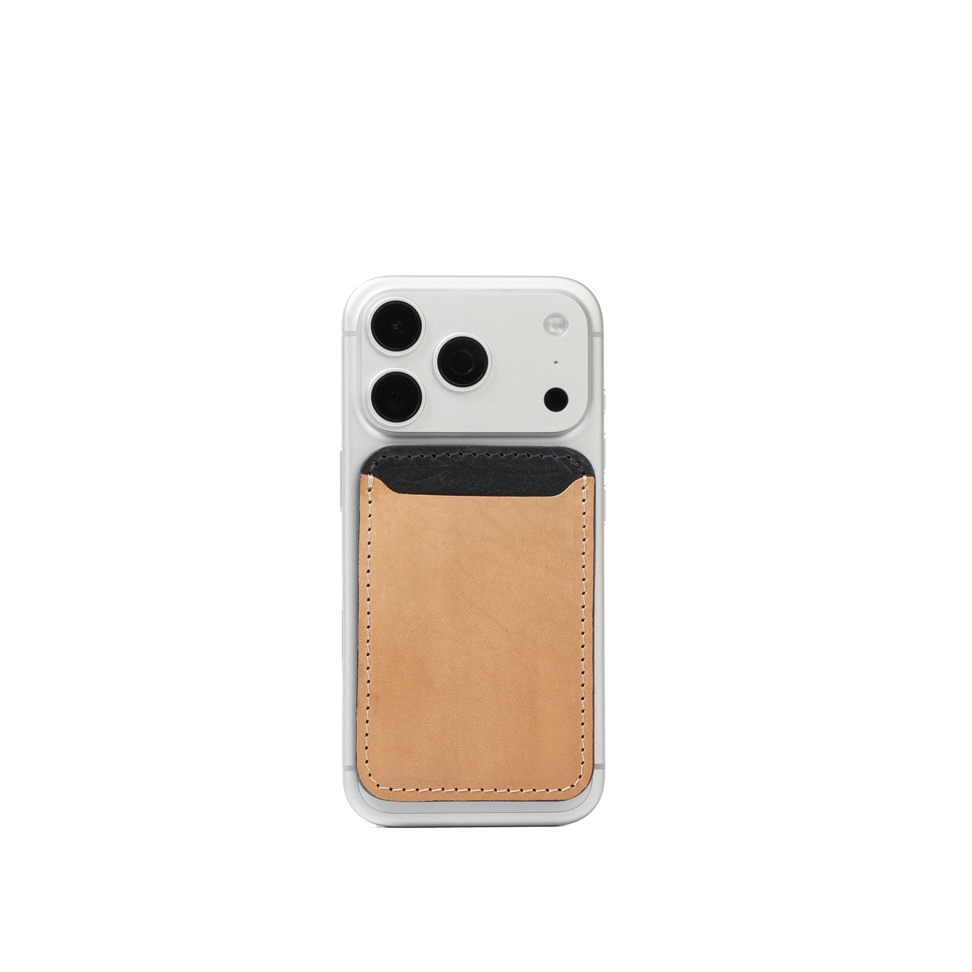 Beige and black leather MagSafe wallet attached to the back of a silver iPhone