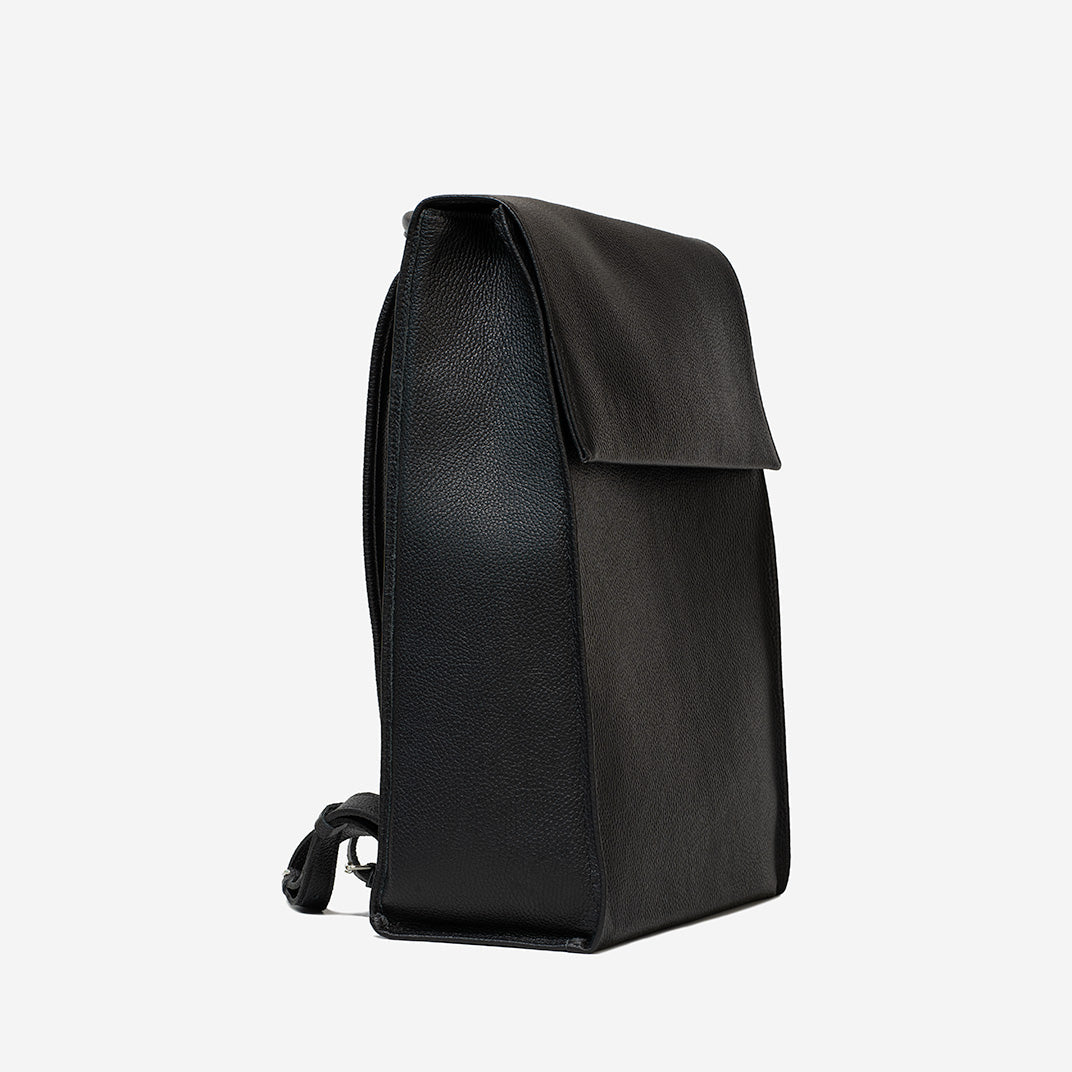 Side view of big leather knapsack with minimalist design, handcrafted from premium Italian leather