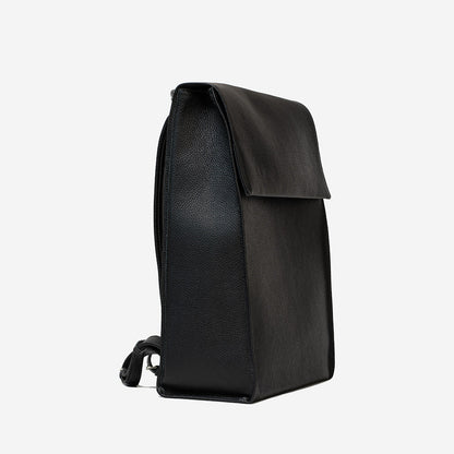 Side view of big leather knapsack with minimalist design, handcrafted from premium Italian leather