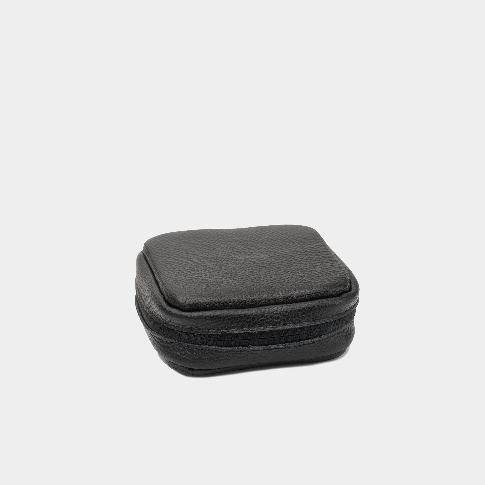 Closed black leather case for Mac Mini with structured shape and zip-around closure