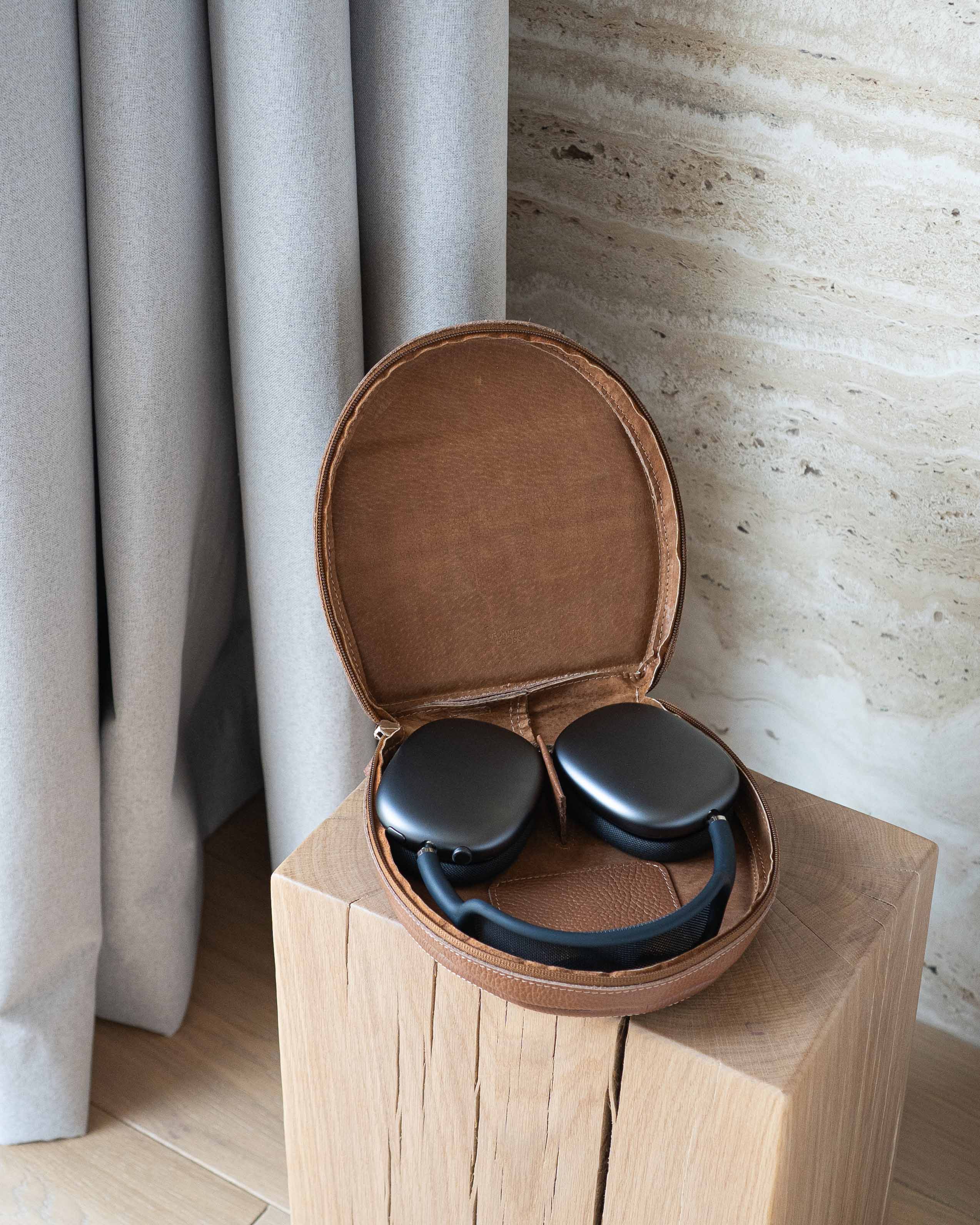 Open brown flat-grain leather case with AirPods Max headphones