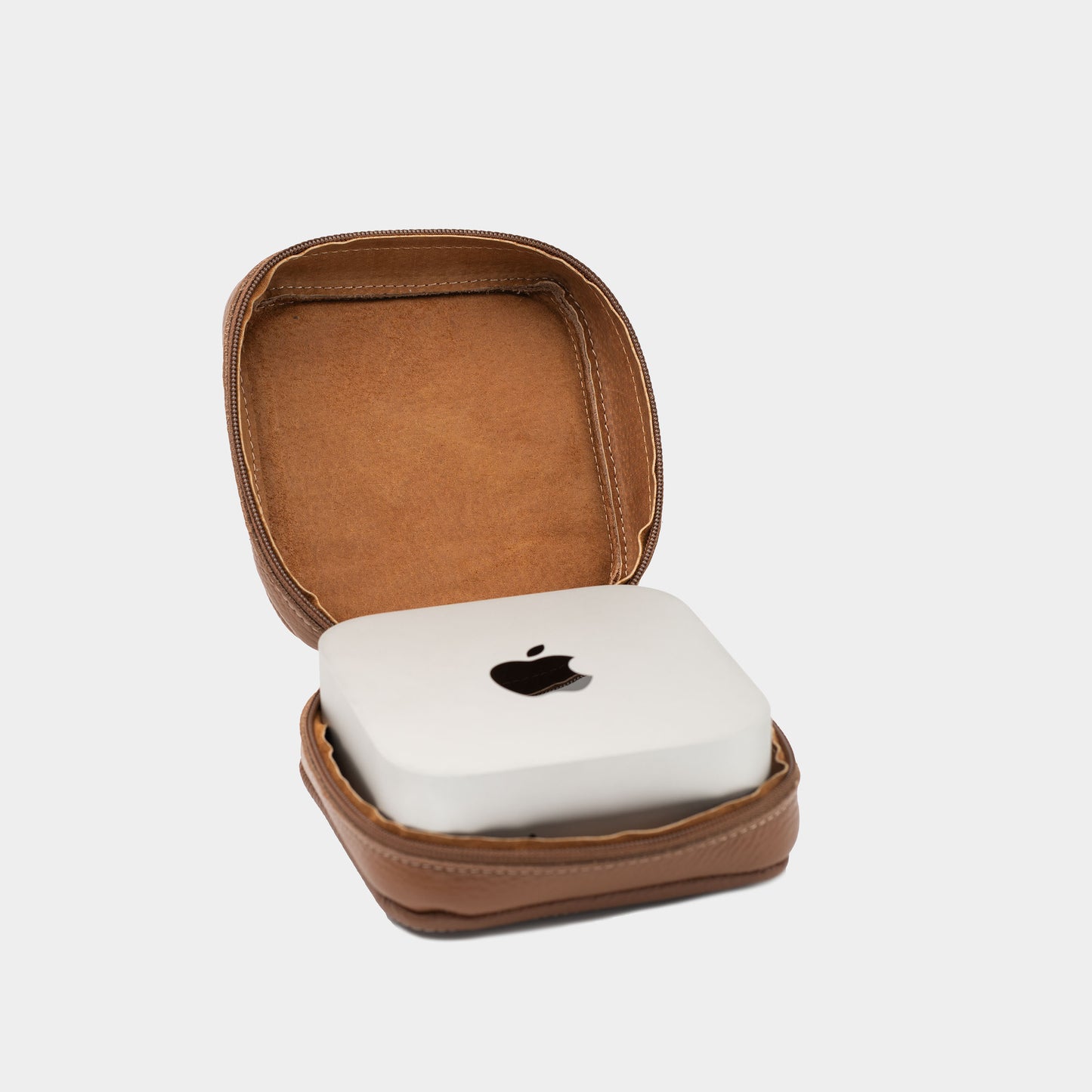 Open brown leather Mac Mini case with matching interior lining and Apple Mac Mini inside