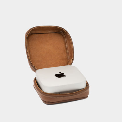 Open brown leather Mac Mini case with matching interior lining and Apple Mac Mini inside