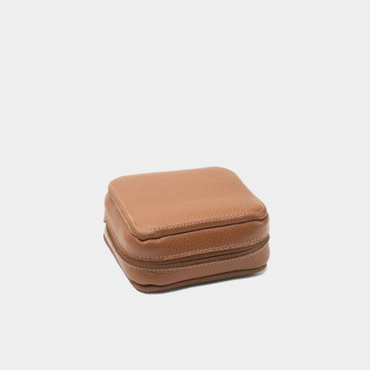 Closed brown leather case for Mac Mini with visible stitching and zip-around closure