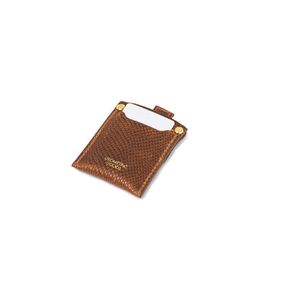 Geometric Goods brown snake print leather AirTag card holder, showcasing card insertion with luxury gold rivet details for a stylish and secure carry