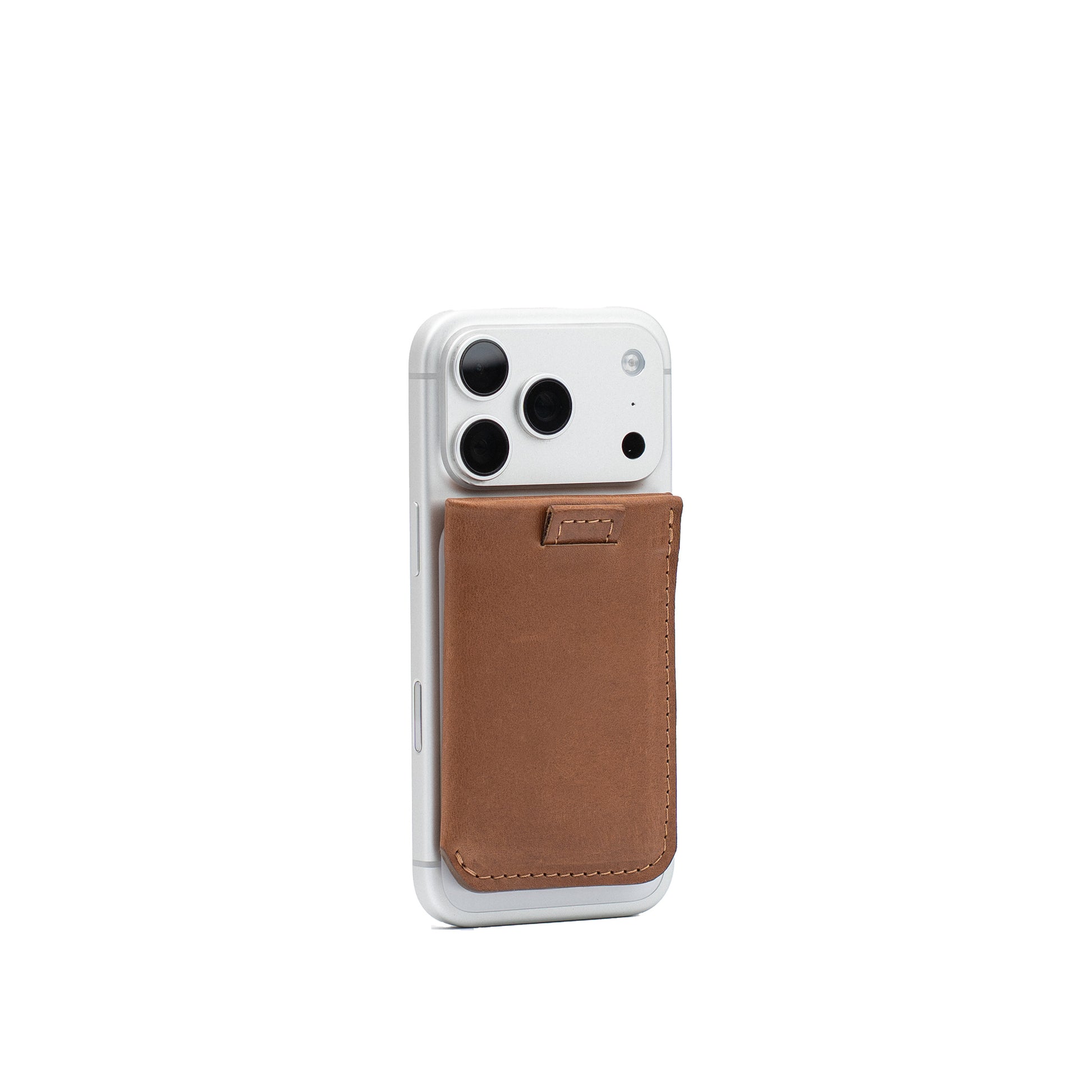 Camel leather MagSafe wallet for 4–6 cards with Vectors pattern attached to the back of a silver iPhone