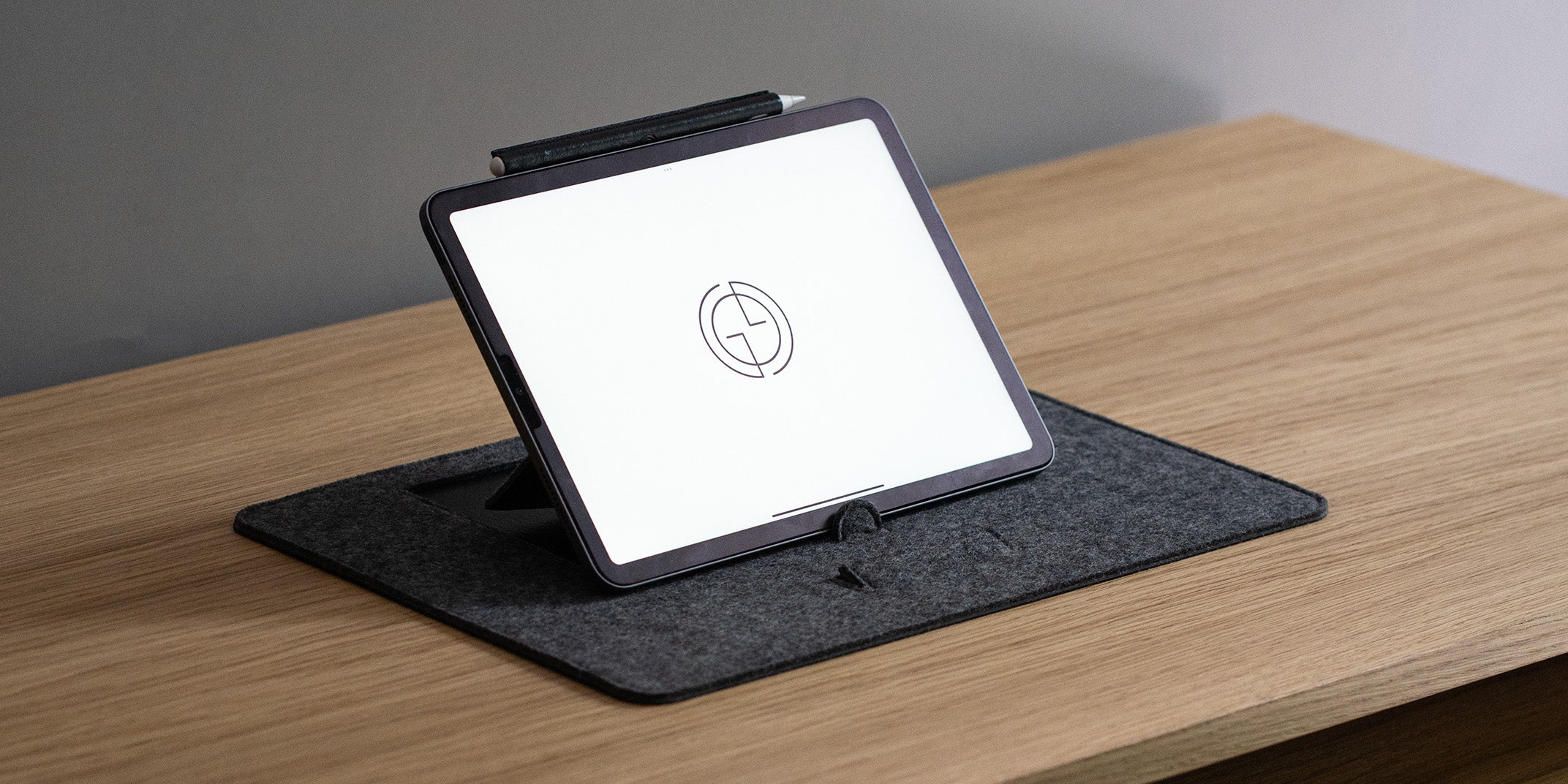 Close-up of grey wool felt desk pad with tablet stand and pen holder