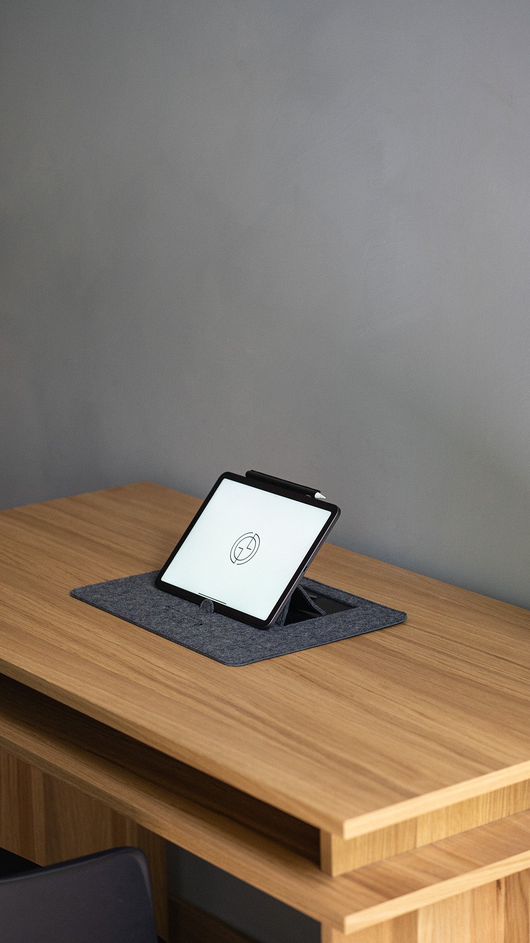 desk pad with ergonomic tablet stand on wooden desk