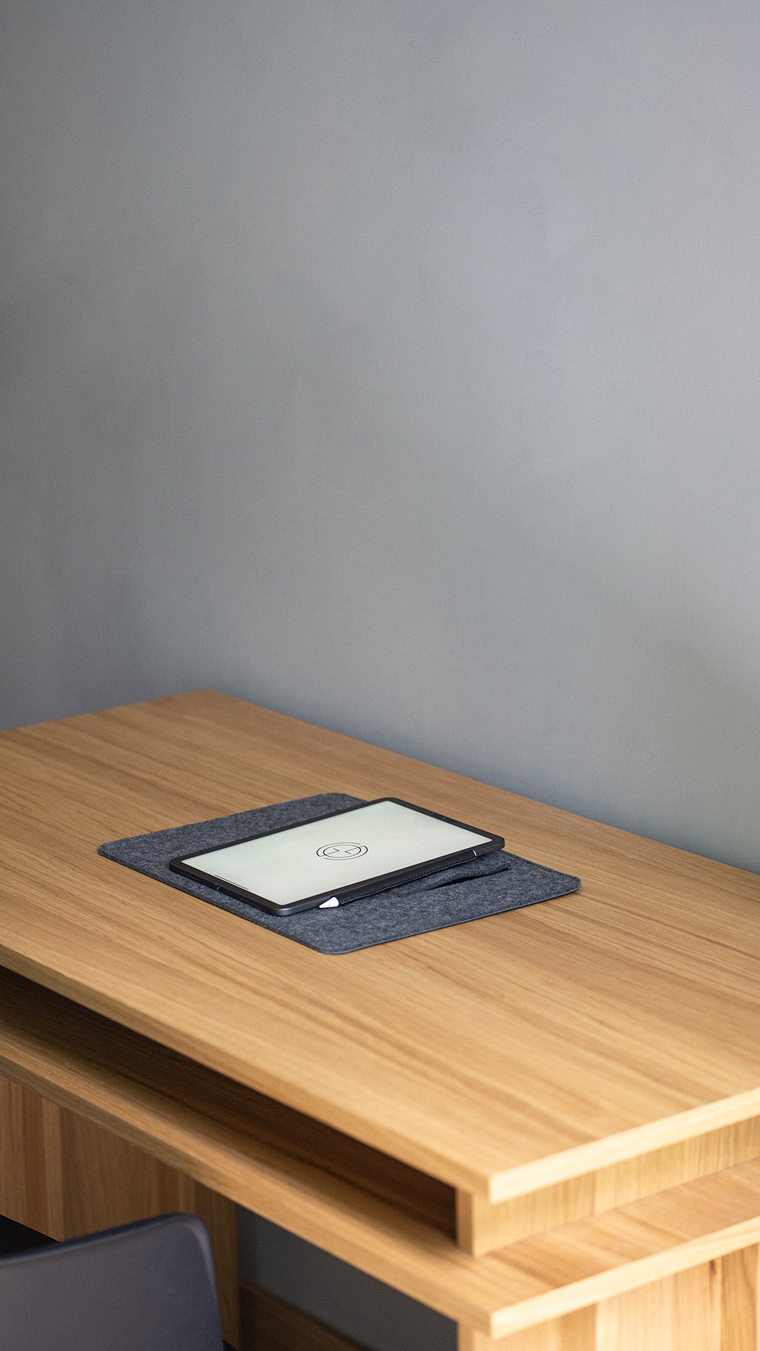 desk pad with fold-flat tablet stand on wooden desk