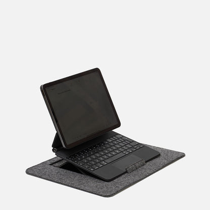 iPad with Magic Keyboard on wool felt desktop stand, showing supported laptop-like setup on grey workspace mat