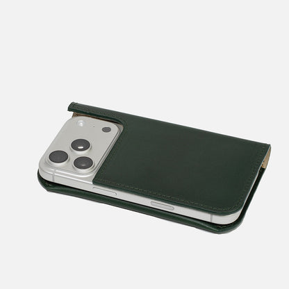 Forest green leather MagSafe folio wallet case on iPhone 17 Pro, closed with camera cutout – Geometric Goods
