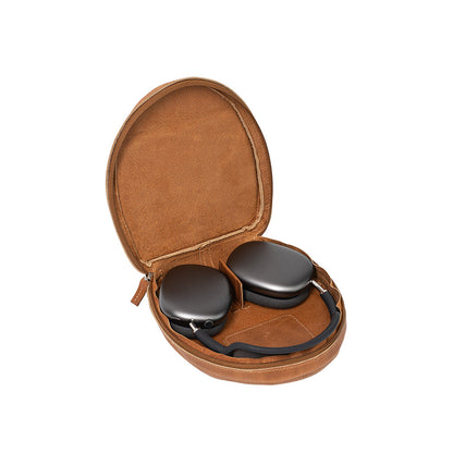 Open brown leather case for AirPods Max by Geometric Goods, showing space gray headphones inside with soft lining and structured interior.