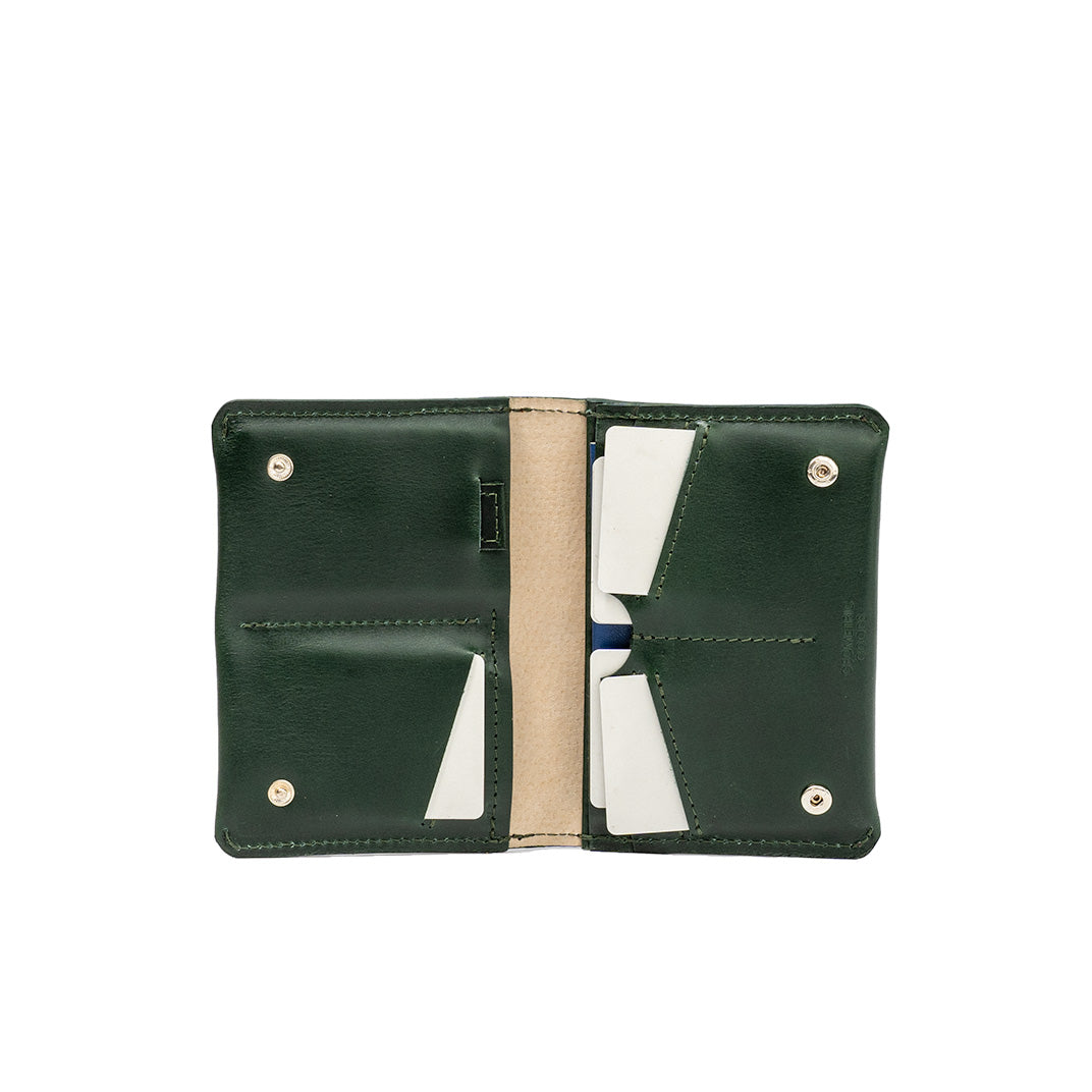 Green leather AirTag passport travel wallet with multiple card slots, dedicated AirTag pocket, and a secure compartment for cash and documents. Sleek design.