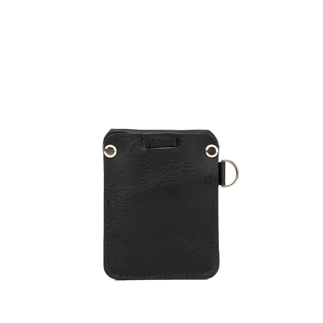 Black leather AirTag wallet by Geometric Goods with smooth finish, D-ring, and rear card slot
