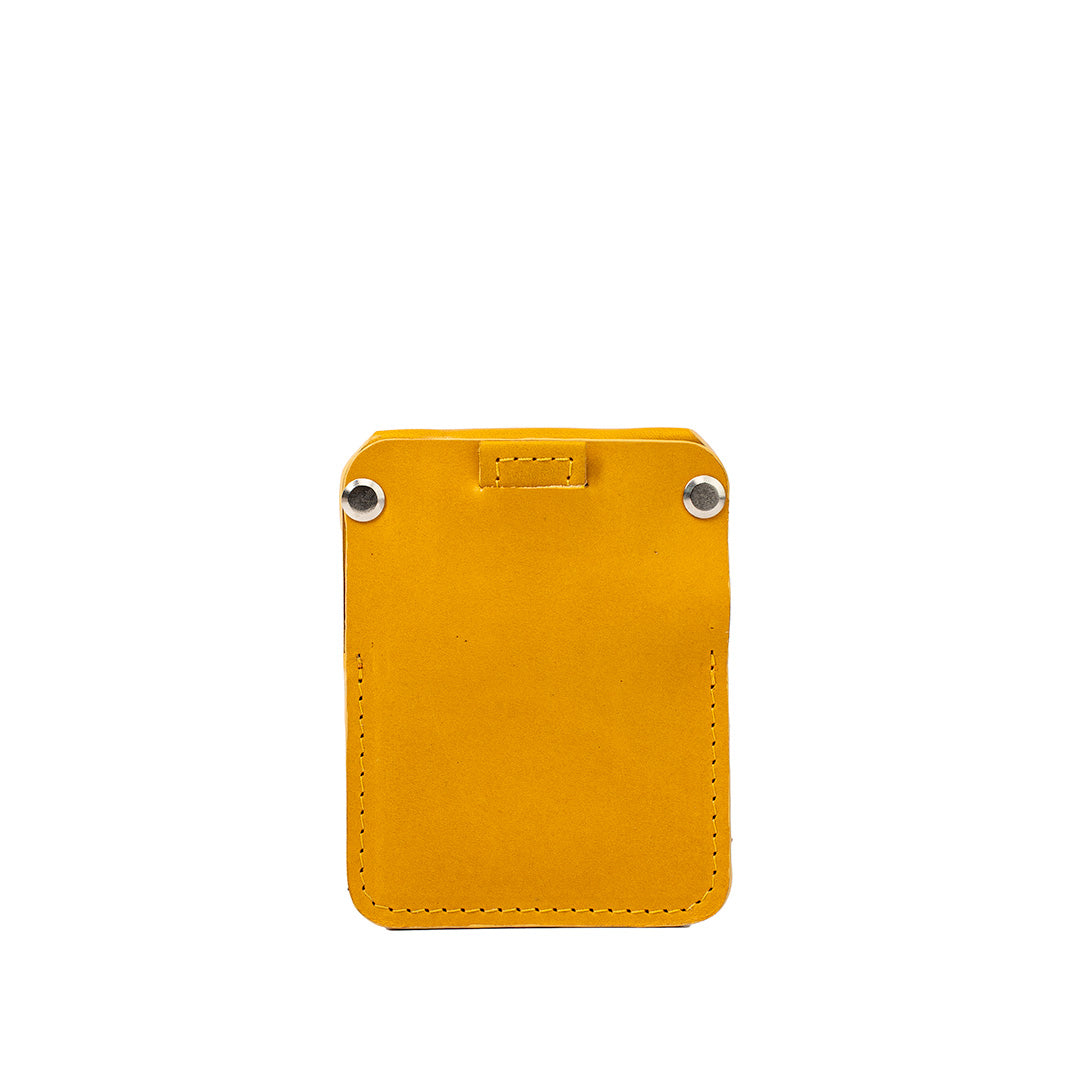 Yellow leather AirTag wallet The Minimalist by Geometric Goods, featuring clean front with silver rivets and rear card slot