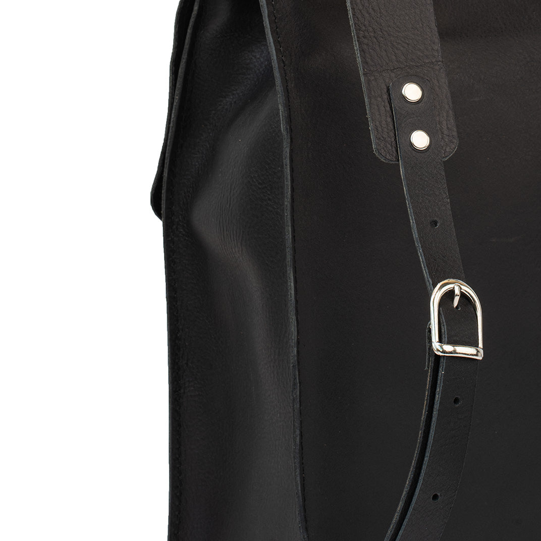 Close-up of the strap detail on the Fibonacci leather backpack, featuring silver-colored hardware and adjustable buckles