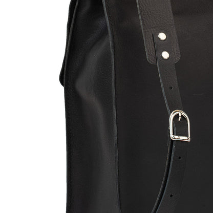 Close-up of the strap detail on the Fibonacci leather backpack, featuring silver-colored hardware and adjustable buckles