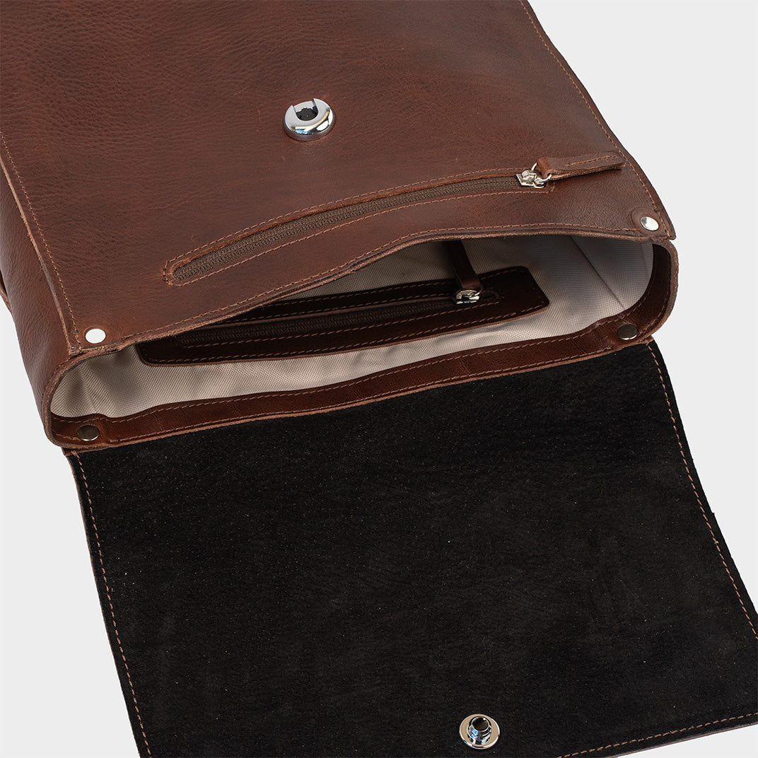 Leather backpack in mahogany, interior view showcasing compartments, ideal for designers and men's use