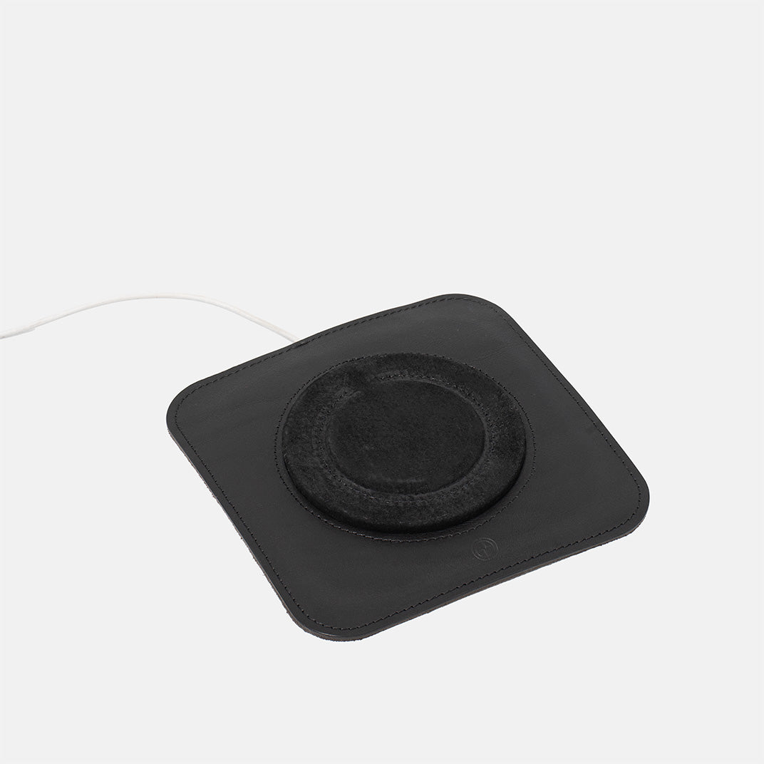 Minimalist black leather MagSafe charging mat for iPhone, premium wireless charger base with soft center