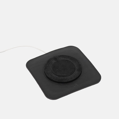 Minimalist black leather MagSafe charging mat for iPhone, premium wireless charger base with soft center