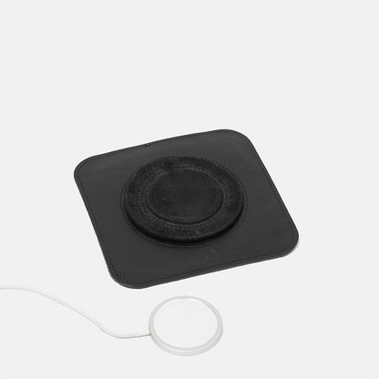 Black leather MagSafe charging mat displayed with separate Apple MagSafe charger, minimalist design