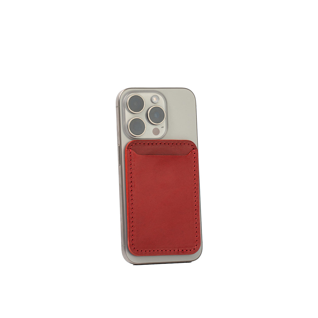 Red top-grain leather MagSafe wallet for iPhone, classic design, handcrafted from Italian leather, shown on iPhone 16 Pro