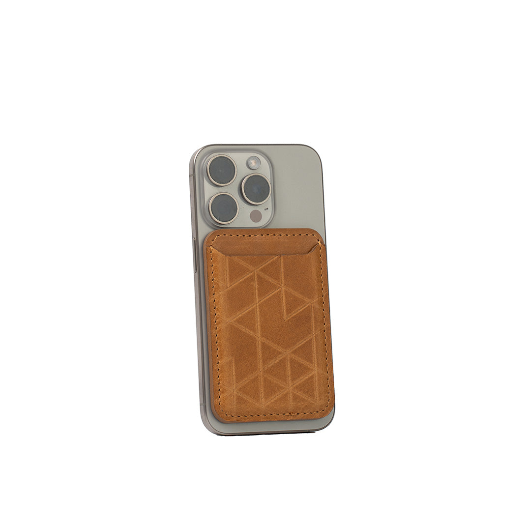 Camel leather MagSafe wallet for iPhone with handcarved Vectors geometric design, vegetable-tanned Italian leather, handcrafted, shown on iPhone 16 Pro