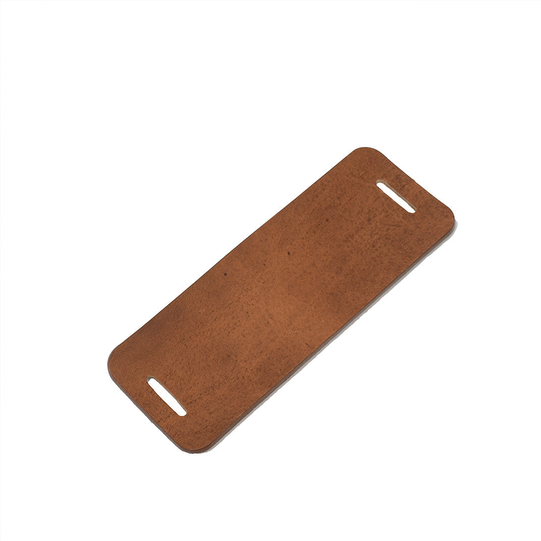 brown leather shoulder pad for shoulder strap displayed flat