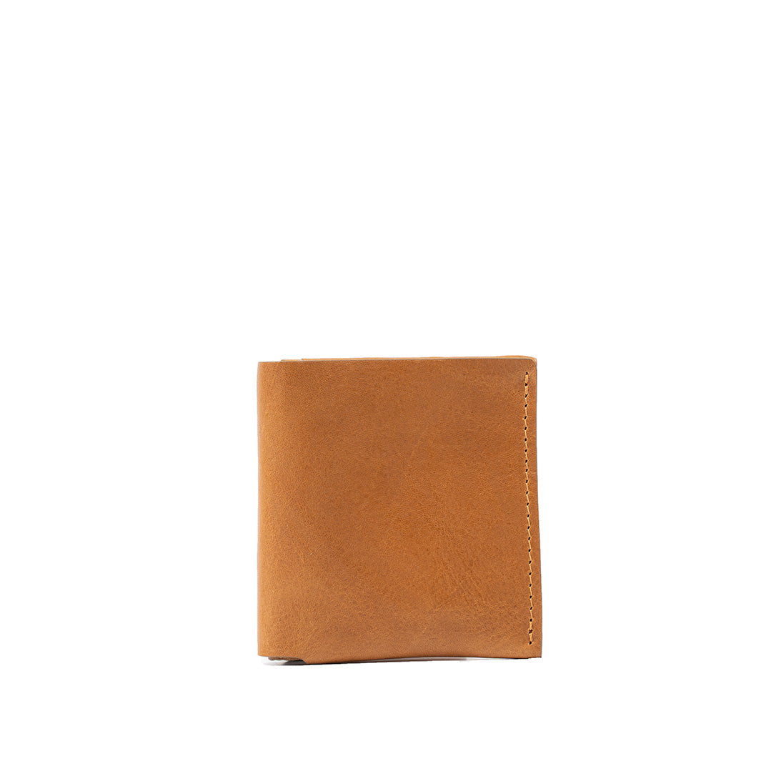Simplistic yet elegant camel-colored leather wallet featuring a minimalist design, finely stitched edges, ideal for those who appreciate understated style and functionality