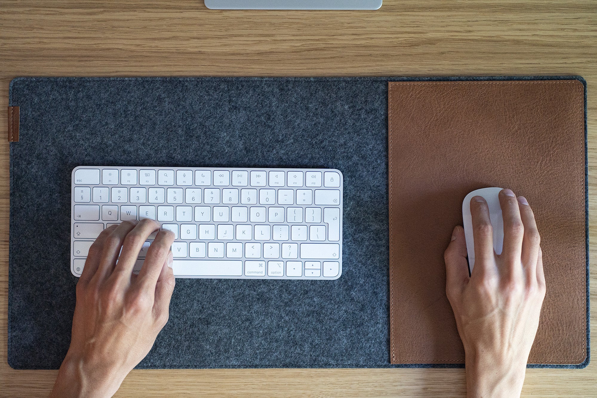 Wool felt and leather desk pad used for keyboard and mouse workspace