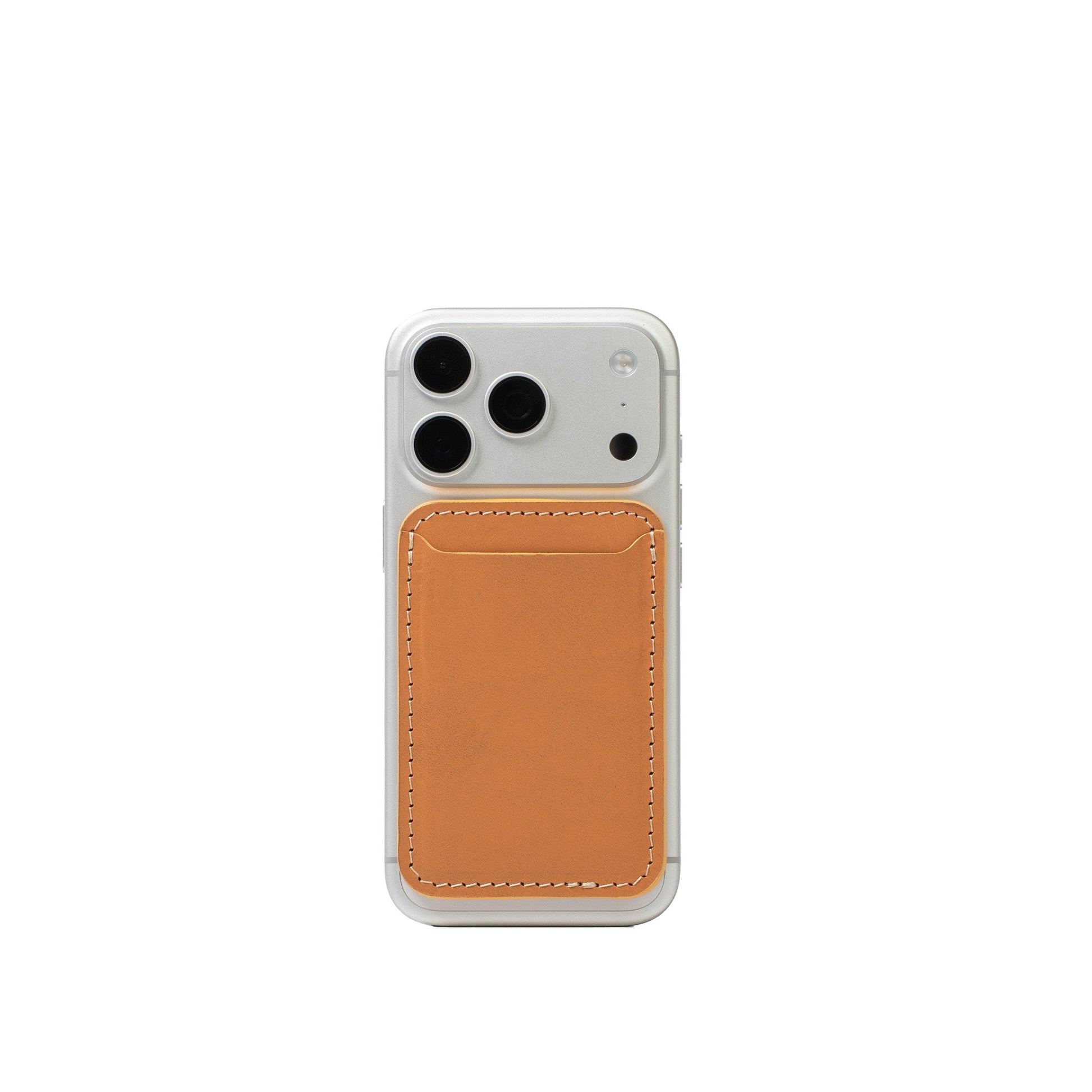 Light orange top-grain leather MagSafe wallet attached to the back of a silver iPhone