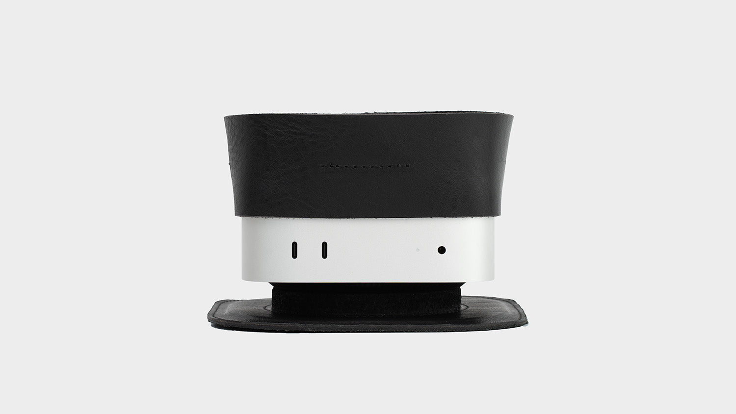 Black leather stand accessory for Mac mini, front view on white background