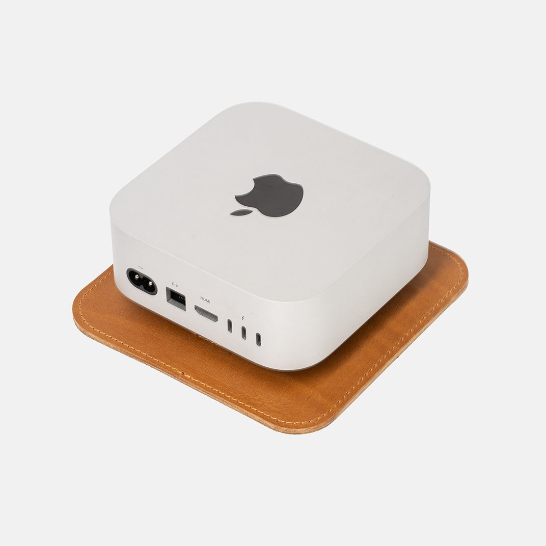 Back view of Mac Mini placed on The Pedestal stand in light brown Italian leather by Geometric Goods.
