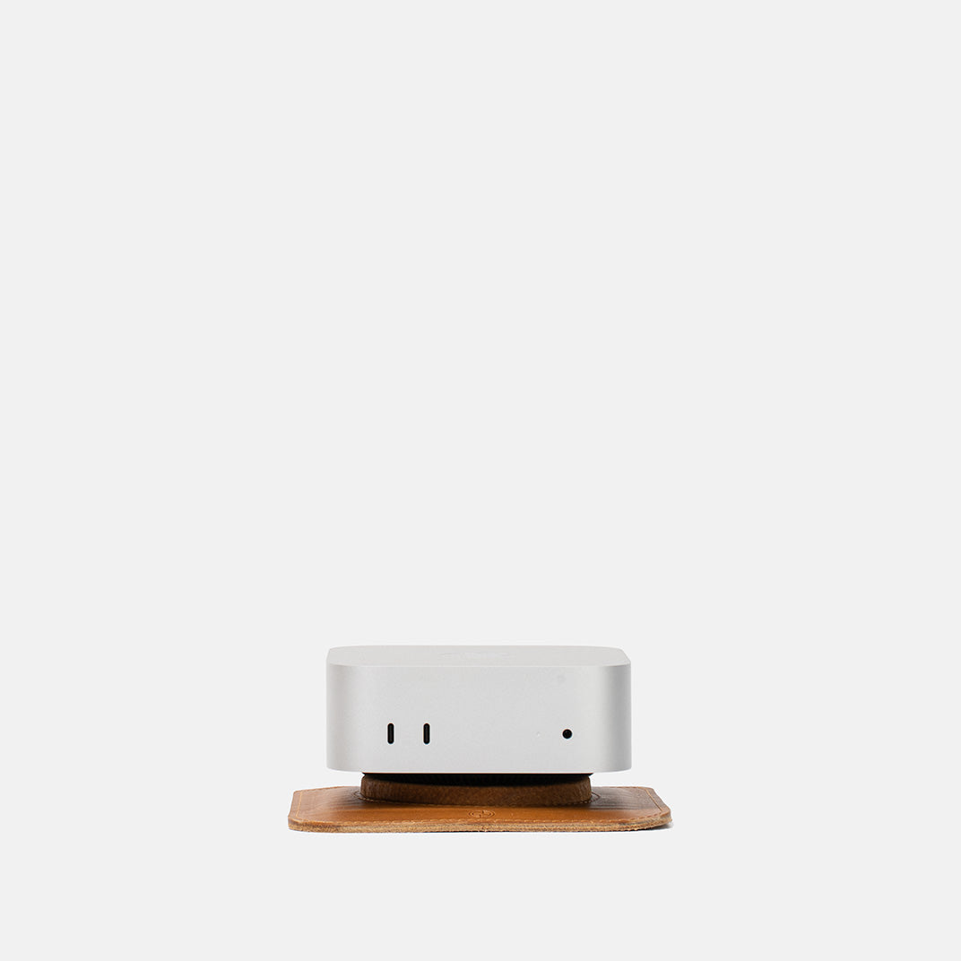 Front view of Mac Mini on The Pedestal stand in camel Italian leather by Geometric Goods, highlighting elevation and access to ports