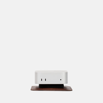 Front view of Mac Mini on The Pedestal stand in mahogany Italian leather by Geometric Goods, highlighting its subtle elevation