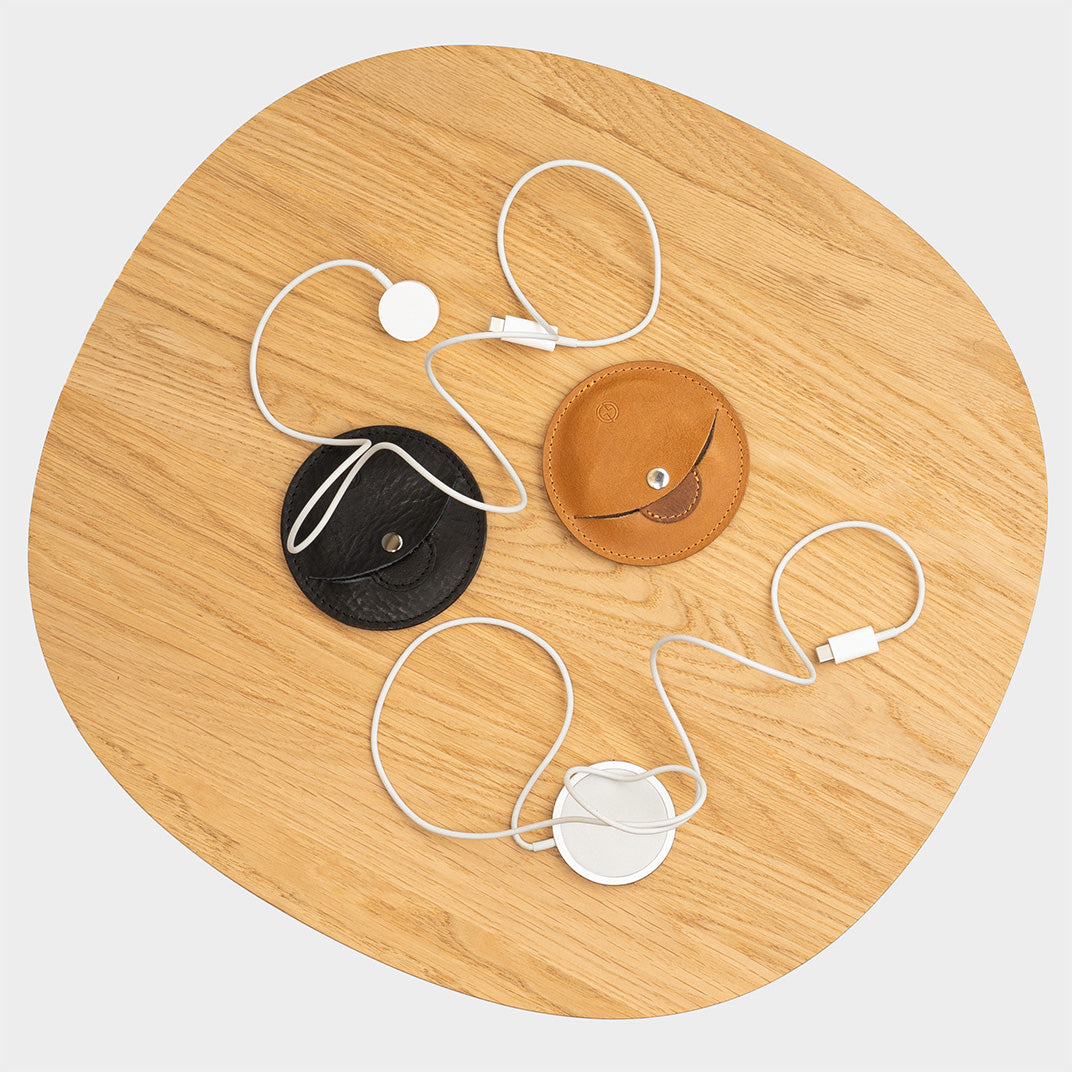 Round leather mouse pad with Apple Magic Mouse on wooden desk